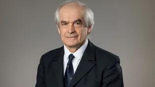 A professional photograph of Professor Gyongy