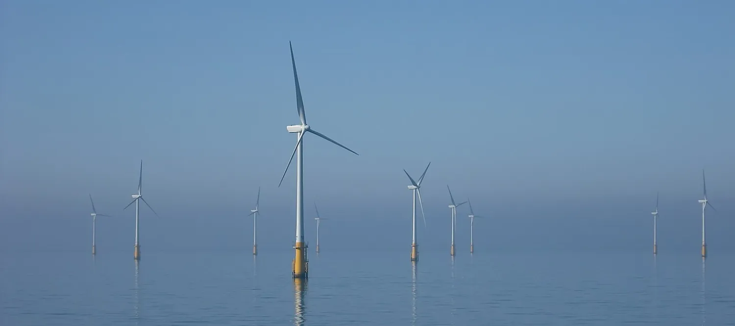A photo looking across the sea to offshore wind turbines at Barrow