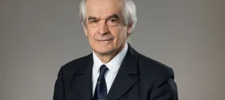 A professional photograph of Professor Gyongy