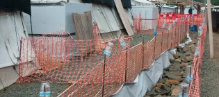 Photo shows a row of temporary tents in an MSF aid facility, Monrovia