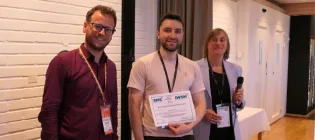 Antoni poses with two members of the Statistical Modelling Society who are presenting him with a certificate