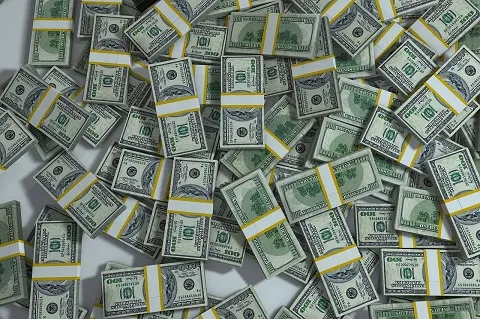 pile of dollars spread out 